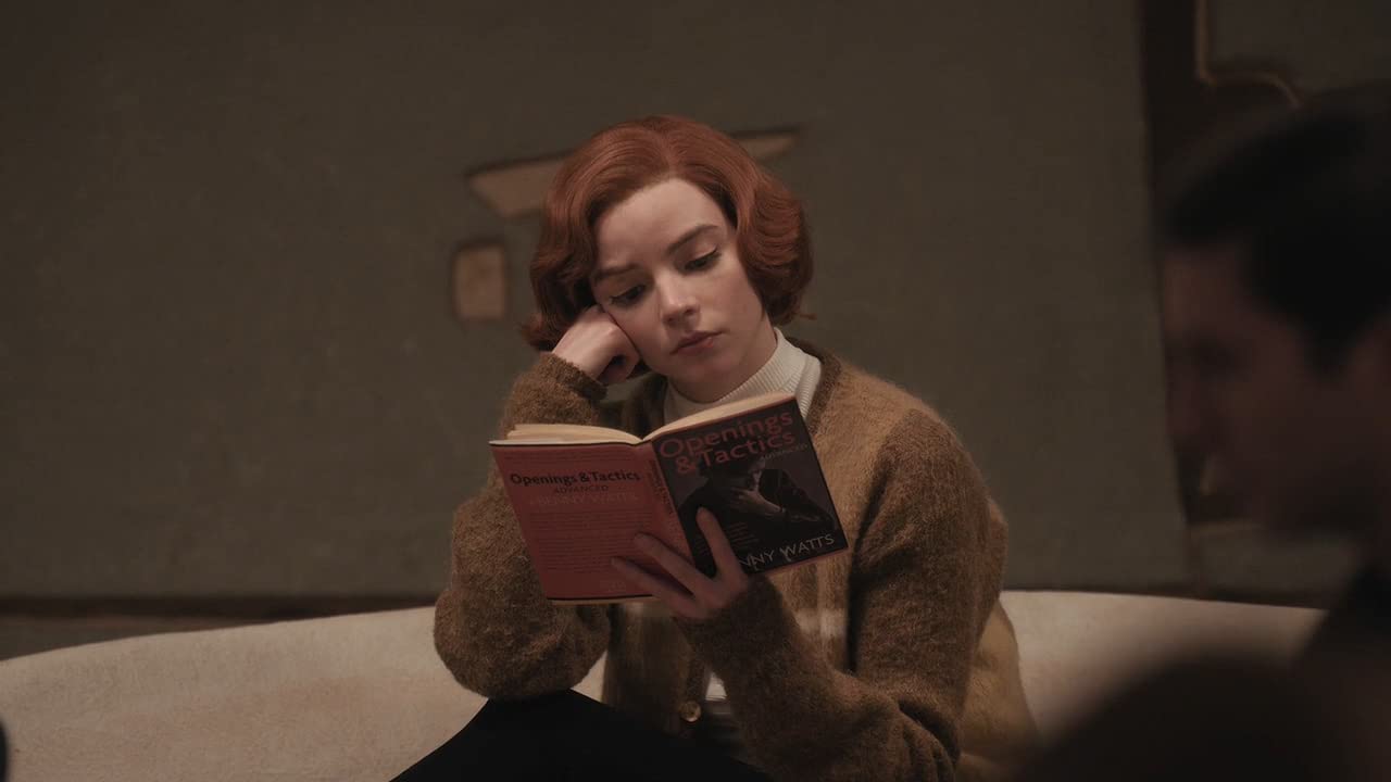 Anya Taylor Joy as Beth Harmon reading in The Queen's Gambit on Netflix
